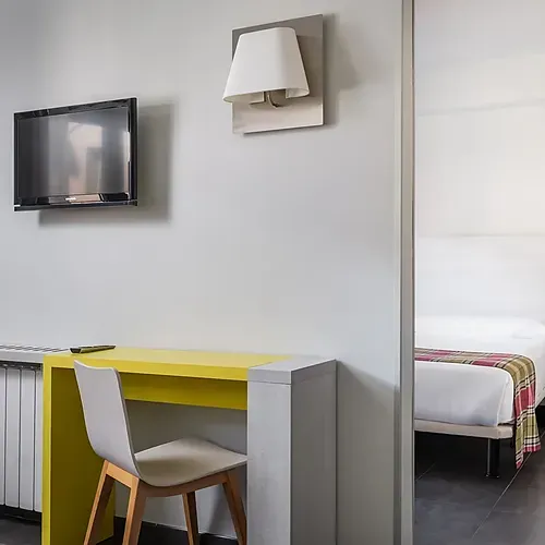 Modern hotel room with two beds and tartan throw at Hotel Cristina | Andorra | Estival Group. Official Web.