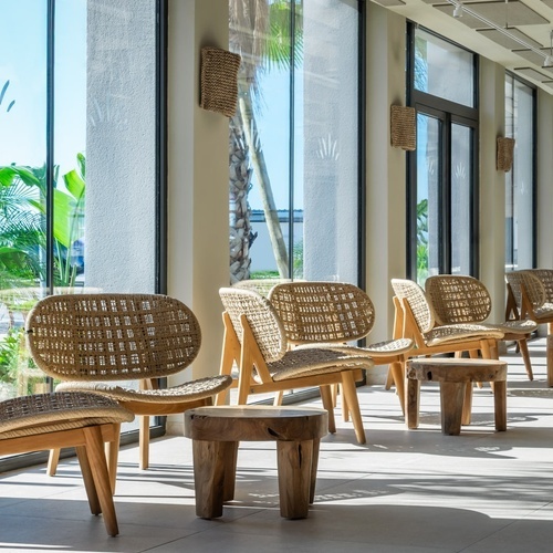a row of chairs are lined up in front of a window
