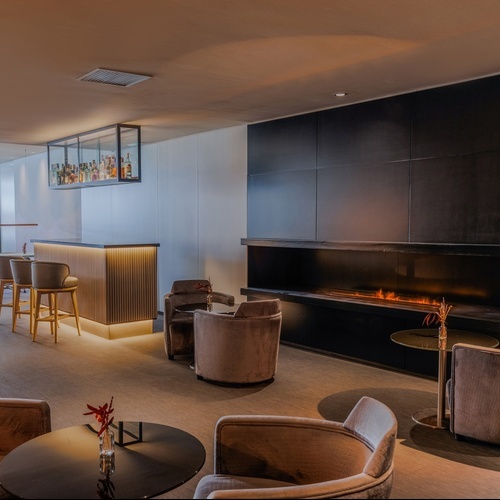 a living room with a fireplace and a bar