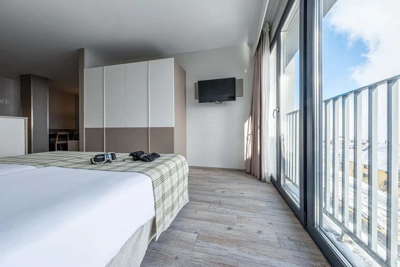 Bedroom with ski goggles and gloves, view from Gallery | Caribou Apartments.