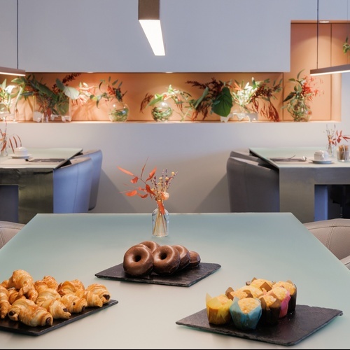 a table with croissants and donuts on it