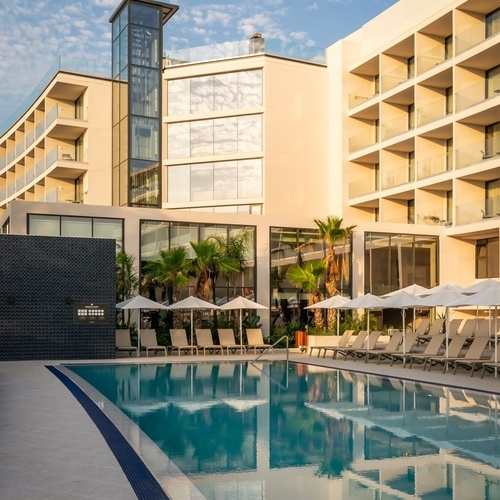 a large building with a swimming pool in front of it