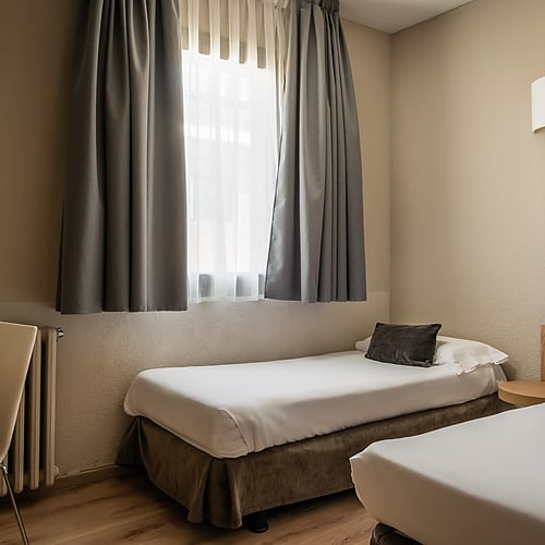 Hotel Sporting Andorra | Grandvalira Pas de la Casa: Spacious room with two beds, desk, and ski-themed decor.
