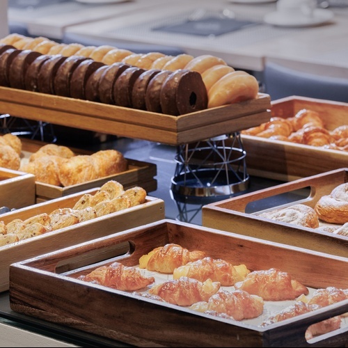 a variety of pastries and donuts are displayed on a table
