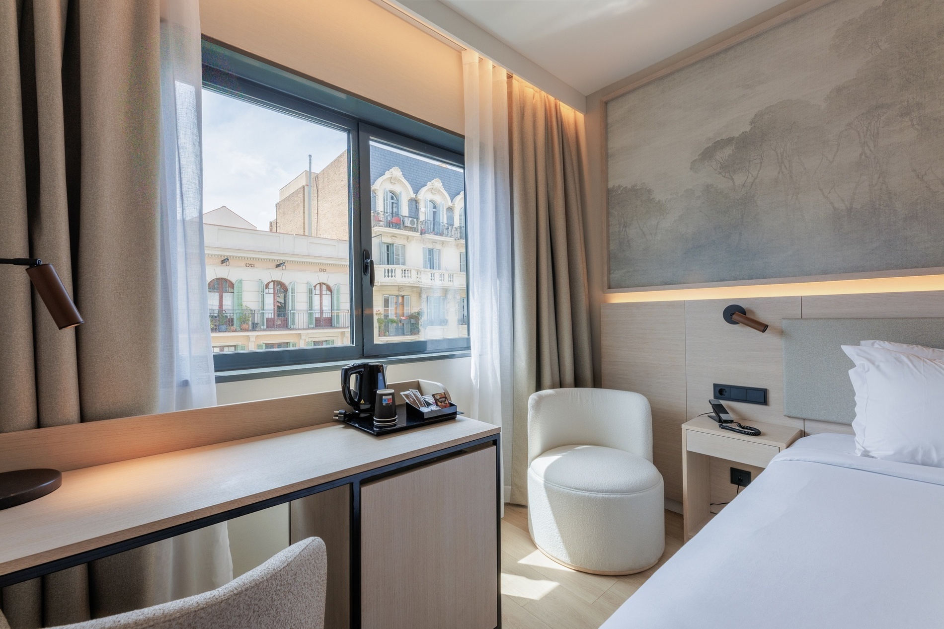 a hotel room with a desk and chair and a window