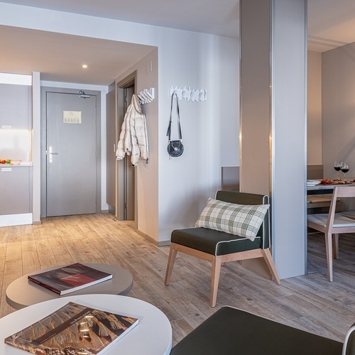 a living room with a table and chairs and a door that says ' hotel ' on it