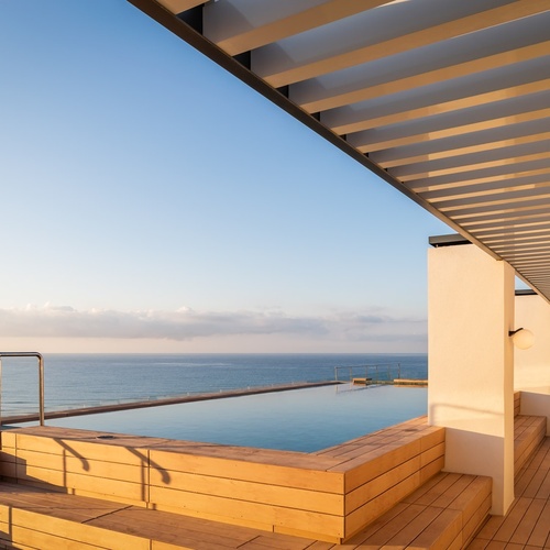 a large swimming pool with a view of the ocean