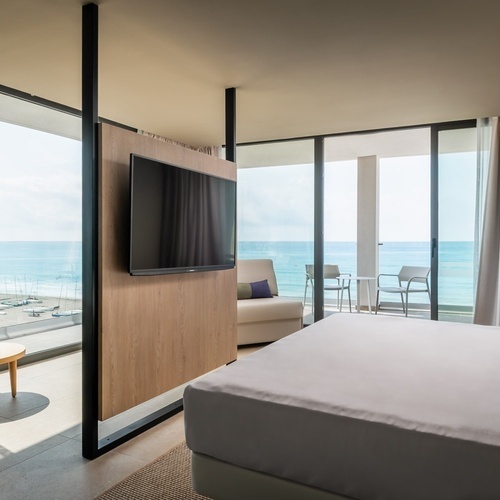 a hotel room with a king size bed and a flat screen tv