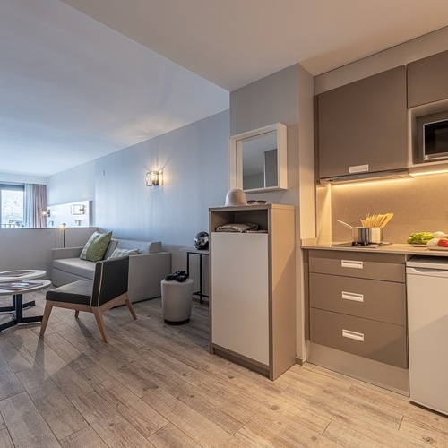 a small kitchen with a microwave and a refrigerator