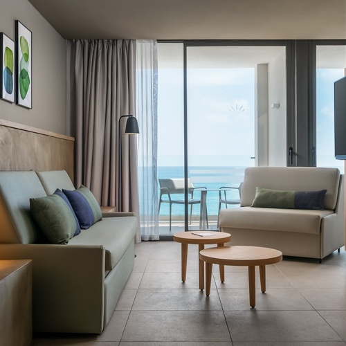 a living room with a couch a chair and a flat screen tv