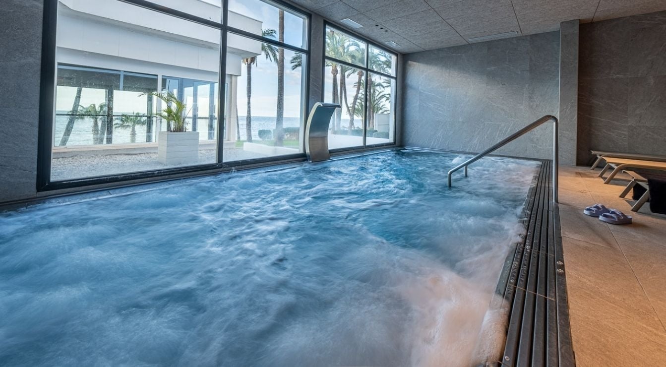 a man stands behind a counter at the estival torrequebrada hotel