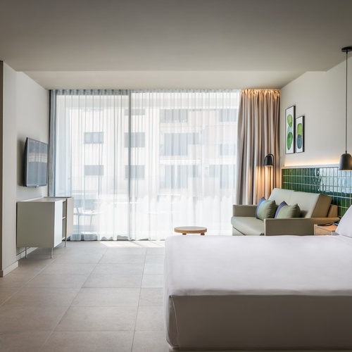 a hotel room with a king size bed and a couch