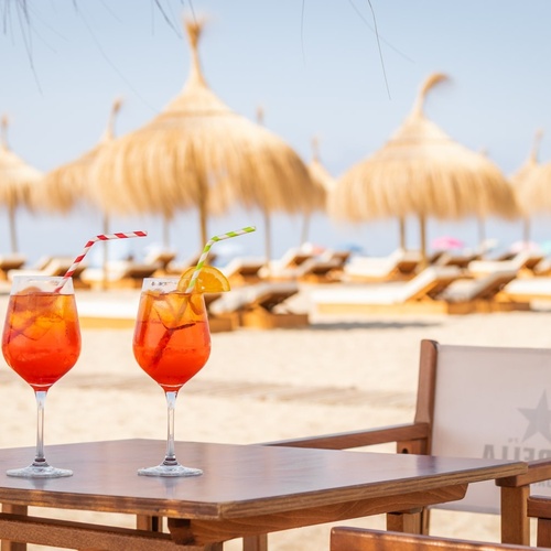 a table with two drinks on it and a chair with a star on it