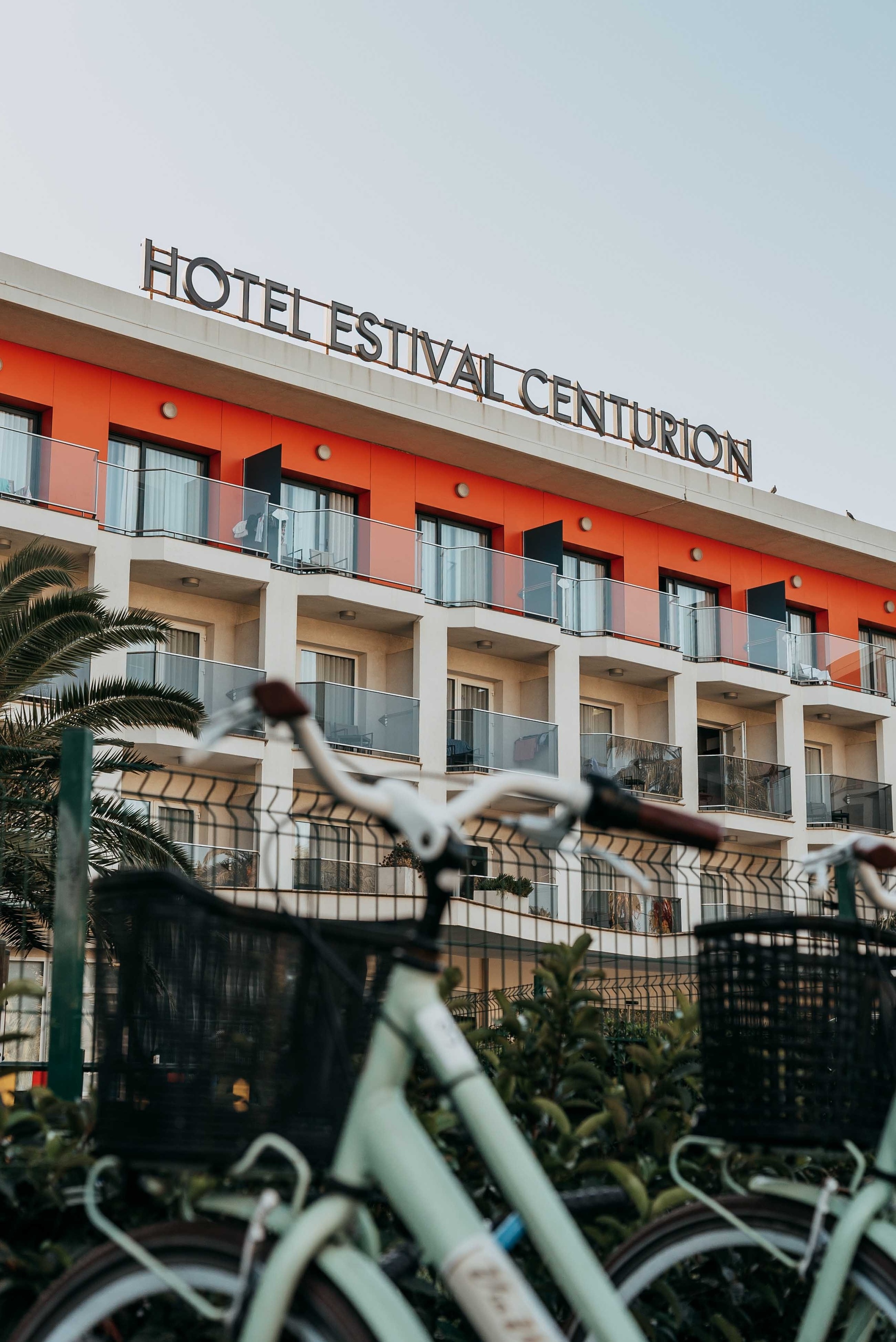 Two golfers, a man and a woman, walk side-by-side across a lush green golf course, both carrying golf bags.