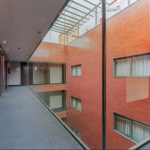 a hallway in a building with a red wall