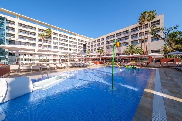 a large building with a pool in front of it