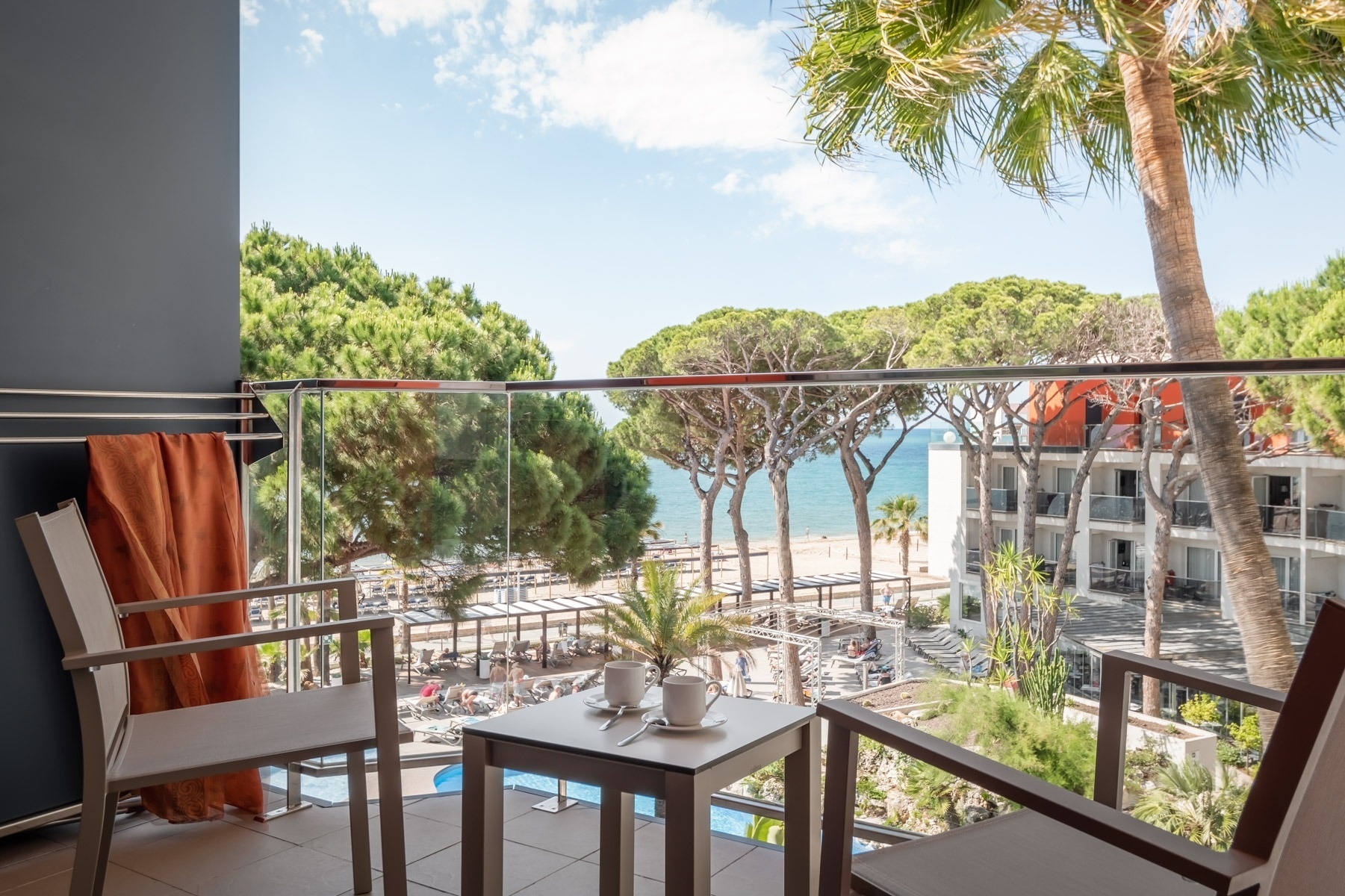 deux chaises et une table sur un balcon avec vue sur l' océan