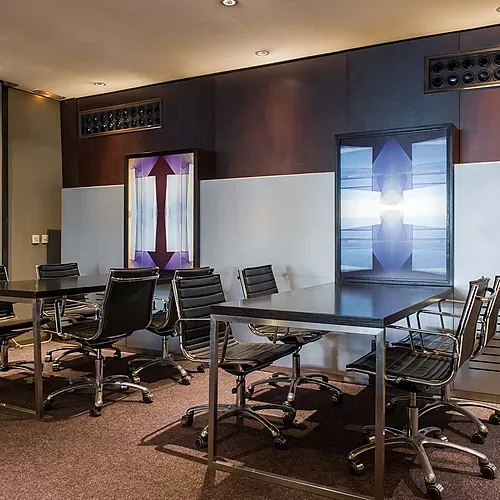 a conference room with a long table and chairs