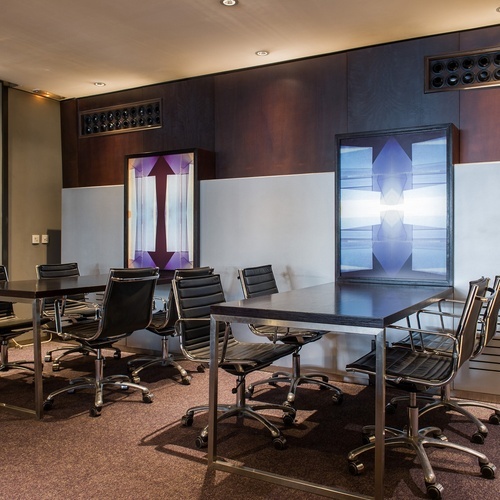 a conference room with a long table and chairs