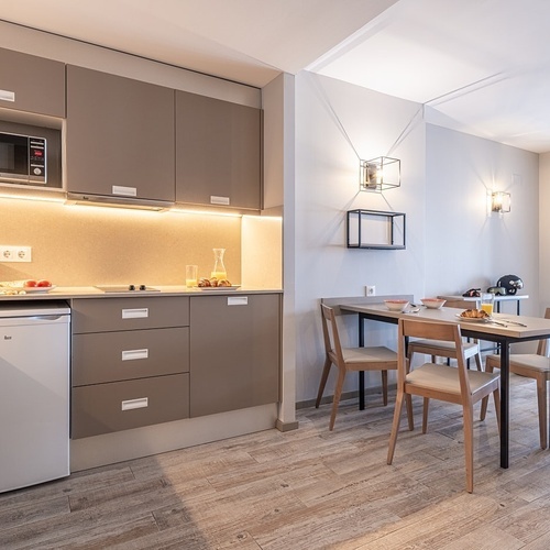 a kitchen with a table and chairs and a microwave