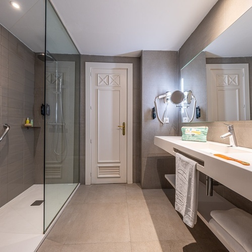 a bathroom with a sink and a walk in shower