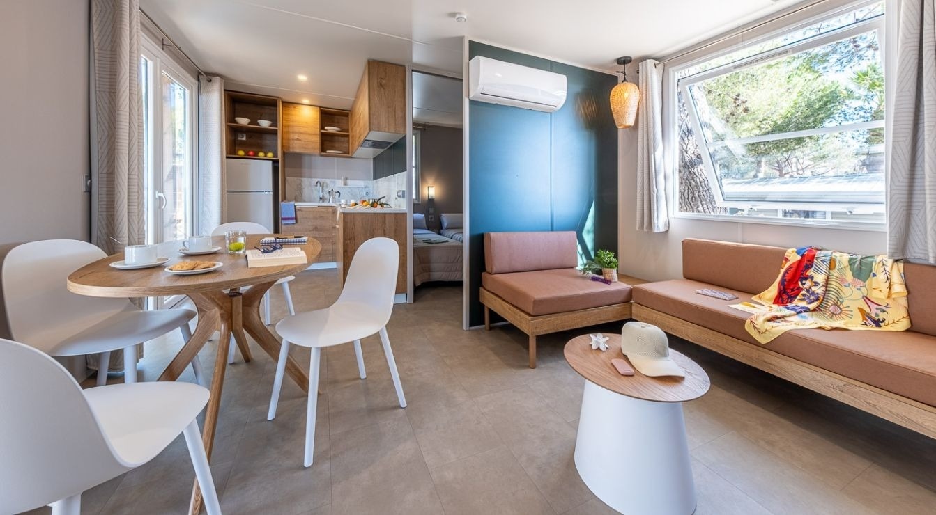 a balcony with two glasses of wine and a plate of food