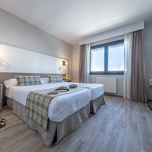 a hotel room with two beds and a television