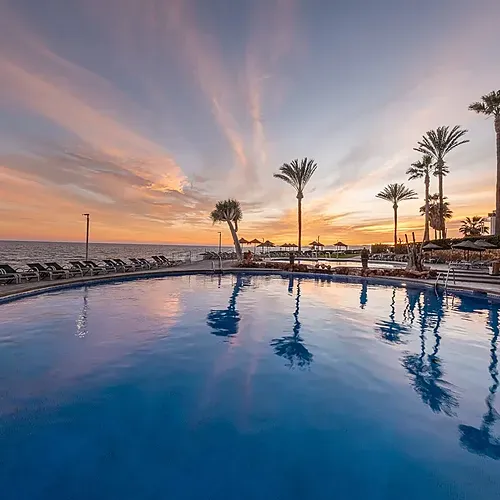 Estival Torrequebrada Benalmádena: Poolside sunset at Estival Group hotel.