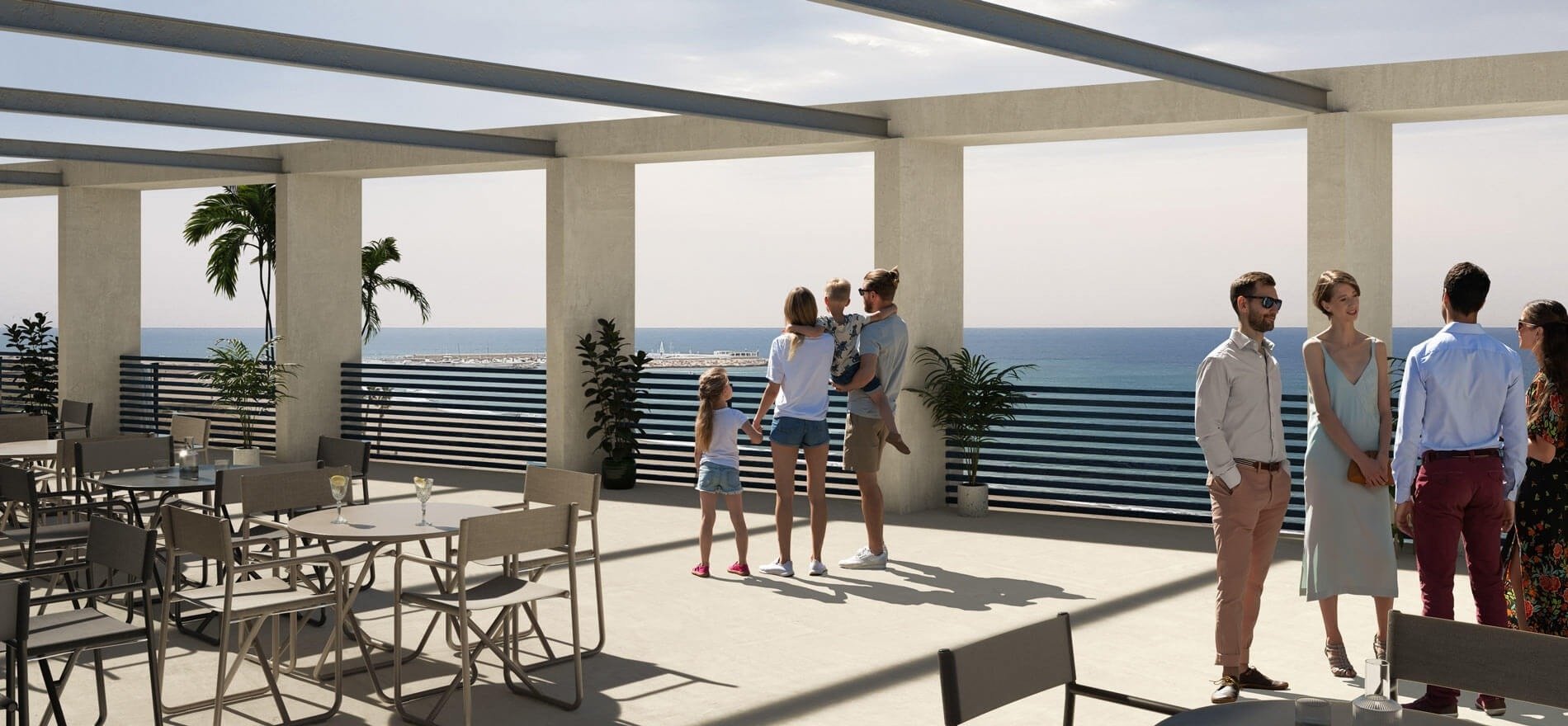 un groupe de personnes debout sur une terrasse avec vue sur l' océan