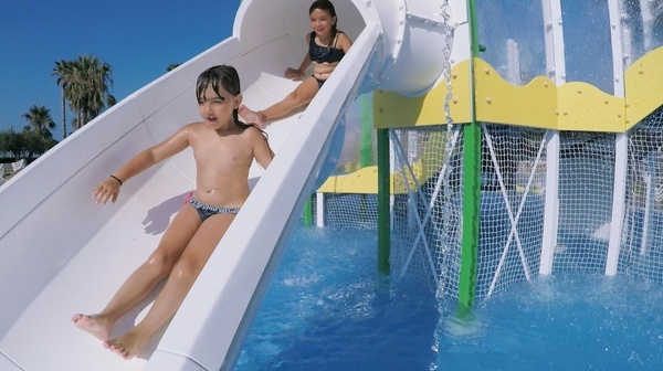 Children sliding down water slide at ESTIVAL: Park Silmar.