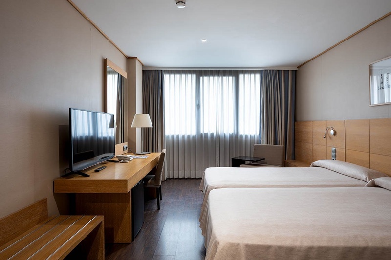a hotel room with a bed and a sliding glass door