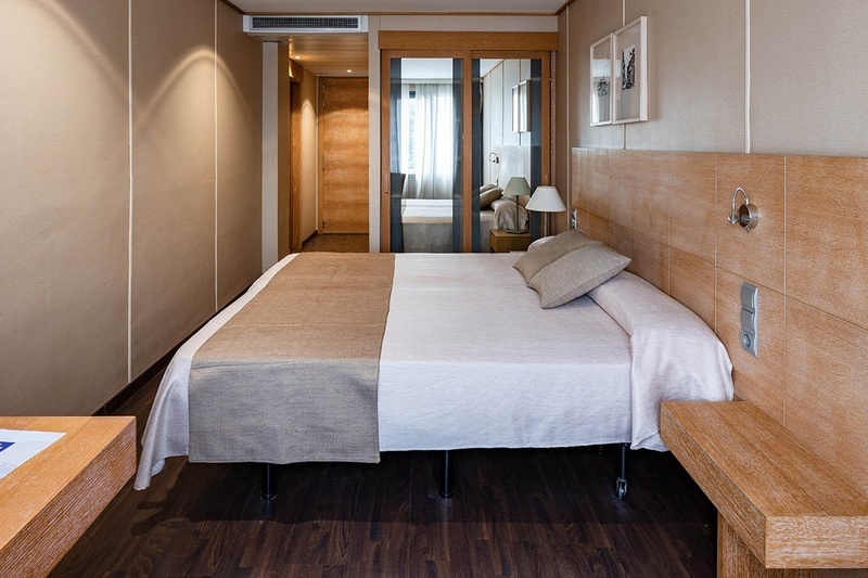 a hotel room with a bed and a sliding glass door