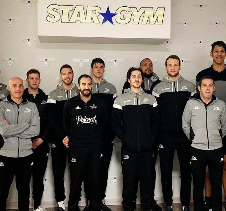 a group of men standing in front of a sign that says star gym