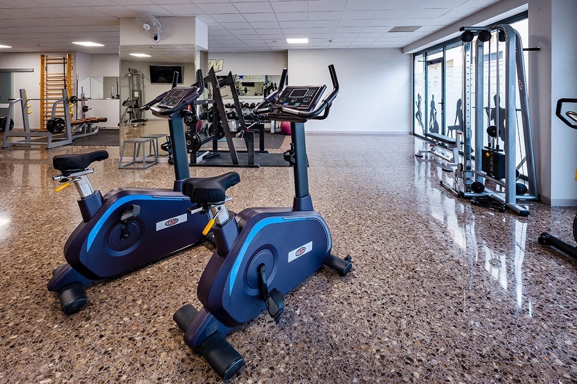 a gym filled with exercise bikes and other equipment