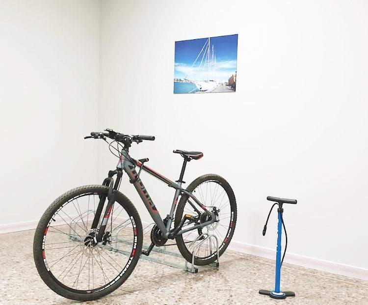a bicycle is parked in a room next to a pump