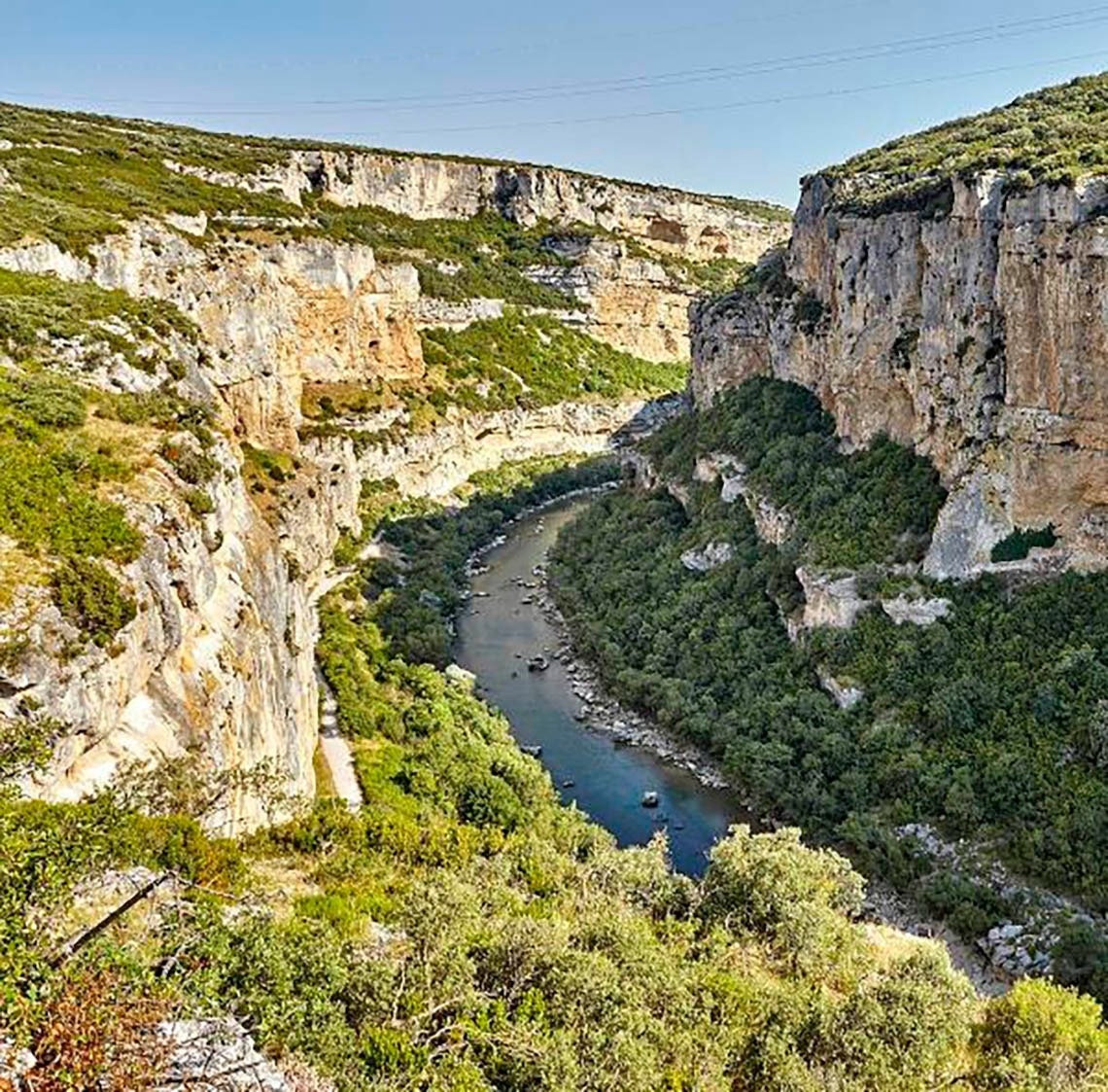 a river flowing through a canyon surrounded by trees
