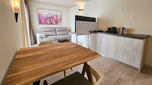 a living room with a wooden table and chairs