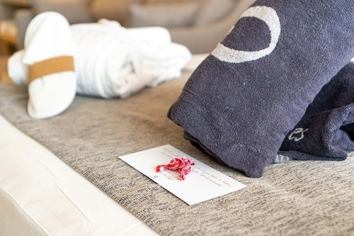 a towel with a crescent moon on it sits on a bed