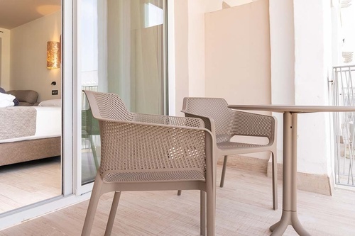 two chairs and a table in front of a sliding glass door