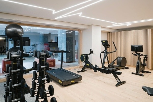 a gym with a treadmill that says technogym on it