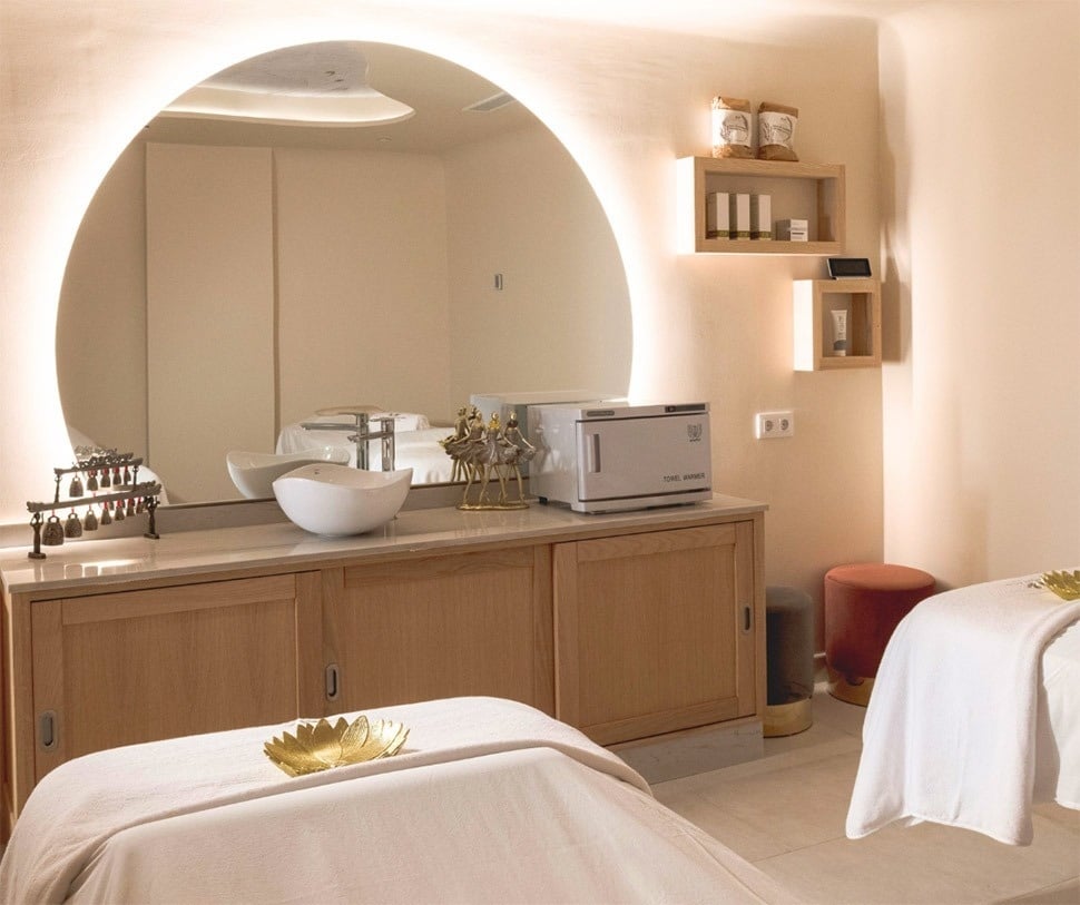 two massage tables in a room with a towel warmer