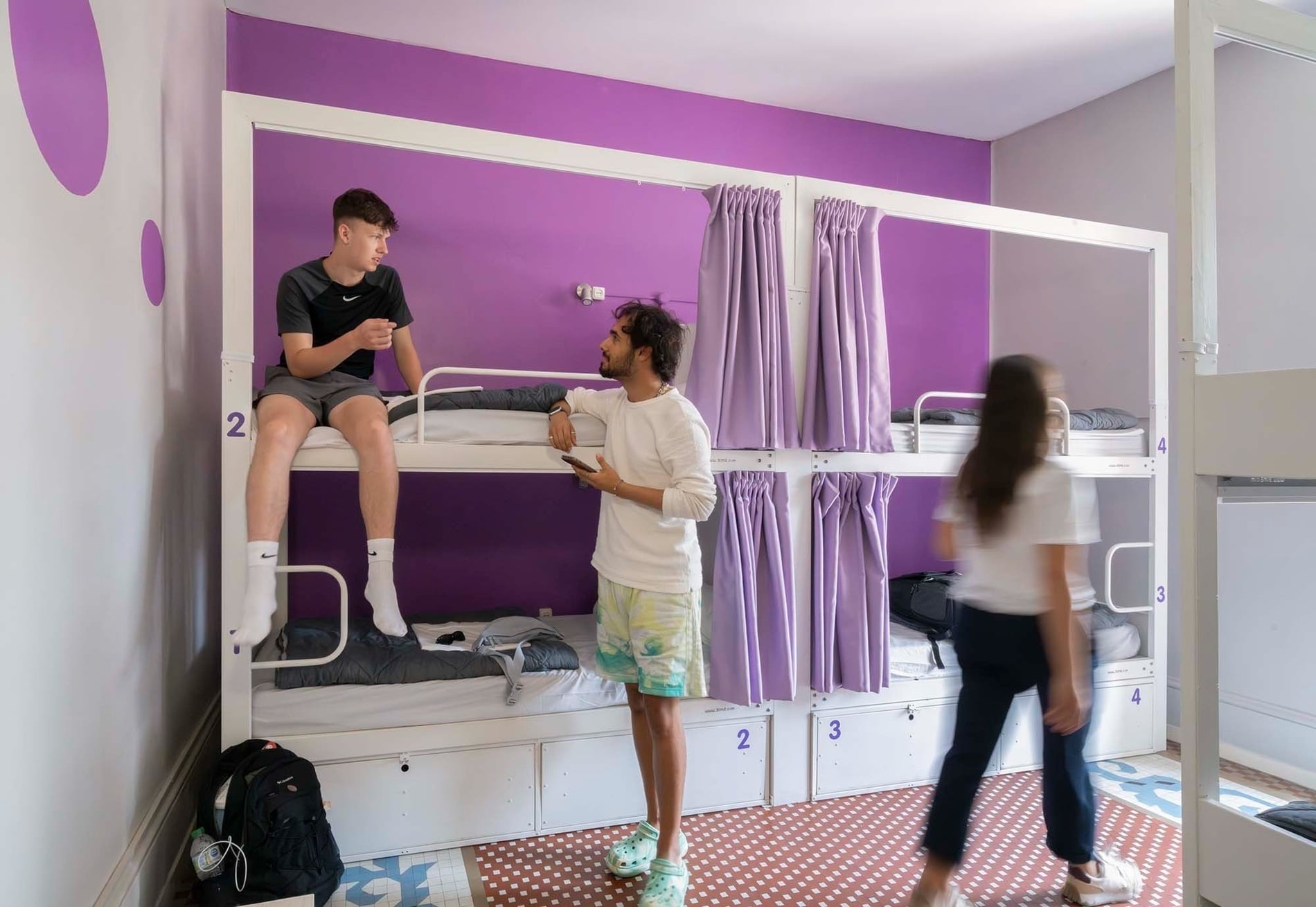 Young men relaxing. Feet up: stylish shared accommodation.