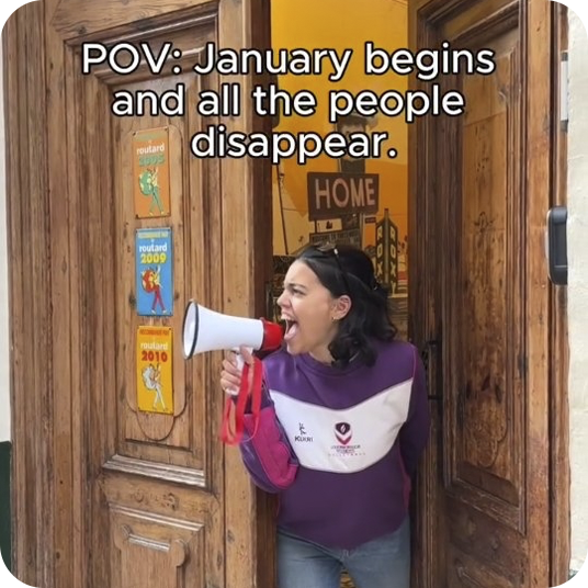 Woman with megaphone announces "January begins and people disappear". Great for "Feet up: Corporativa".