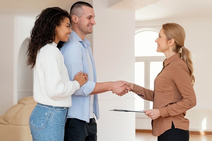 Couple seals real estate deal; feet up with corporate offer.