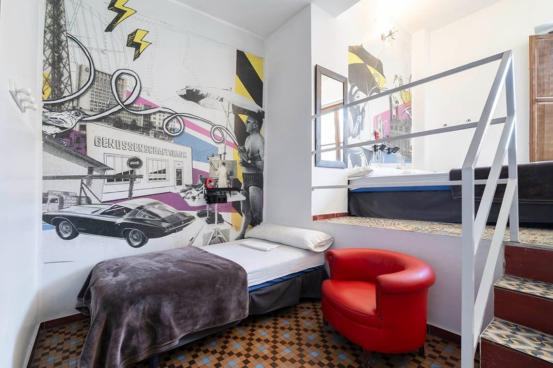 Hôme Youth Hostel Valencia | Feet Up | Valencia: Retro-themed room with bunk beds and unique murals.