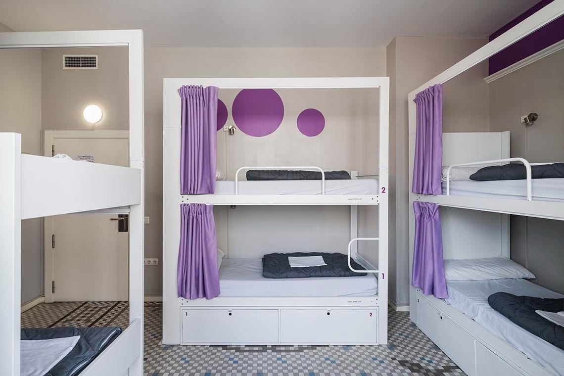 Bunk bed with purple curtains and plenty of foot room. Relax and put your feet up!