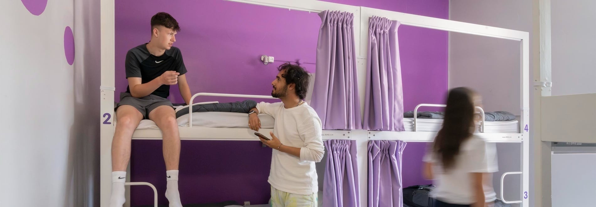 Bunk beds with purple curtains at Purple Nest Hostel Valencia | Feet Up | Valencia | Official website