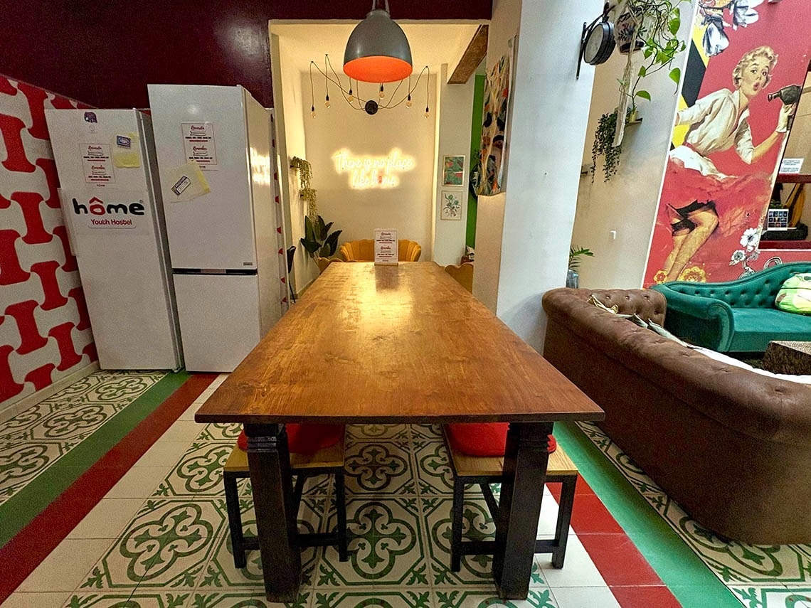 Shared dining area in hostel, perfect for relaxation. Feet up: Relax!