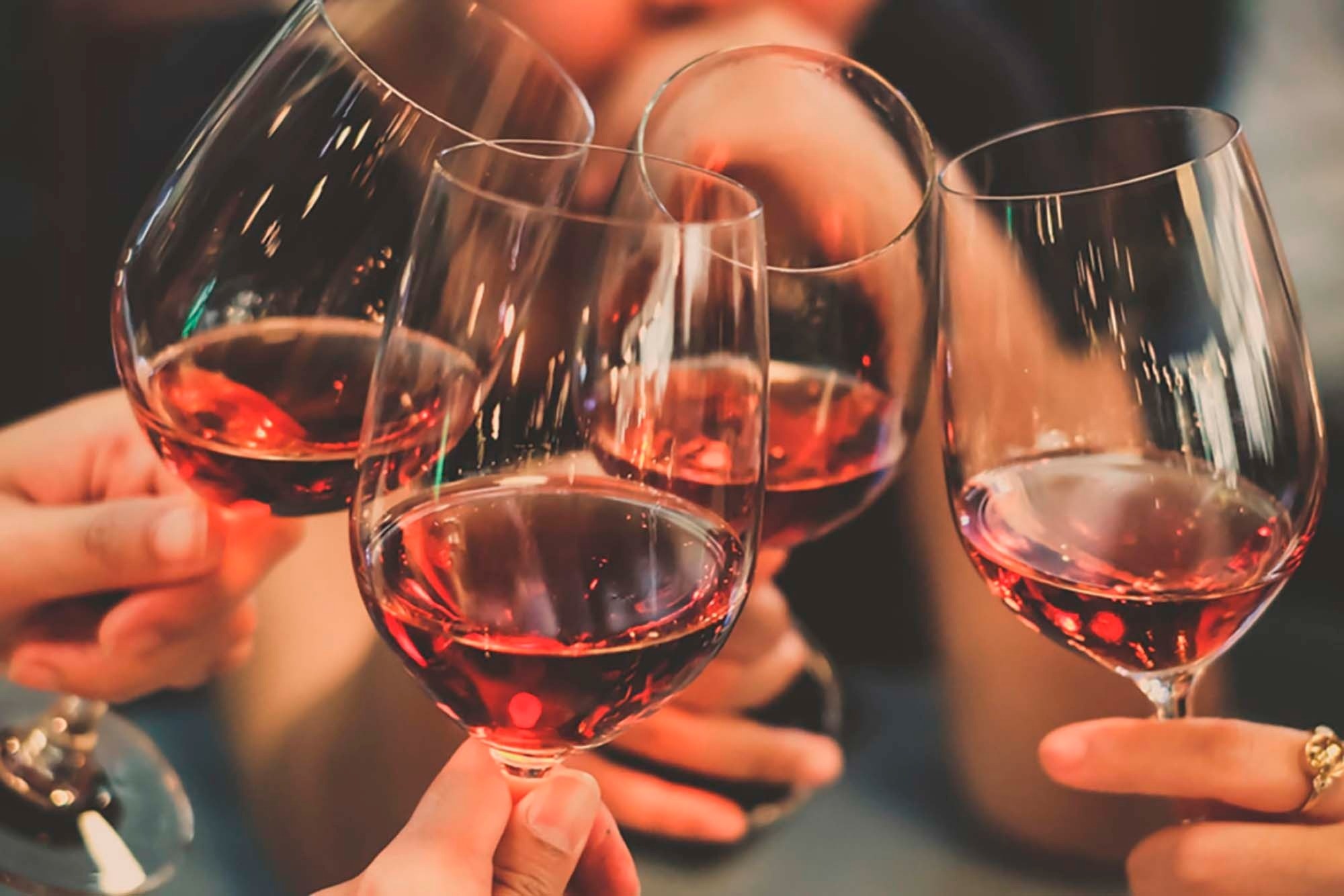 Cheers with red wine glasses. Feet up: Corporate getaway.