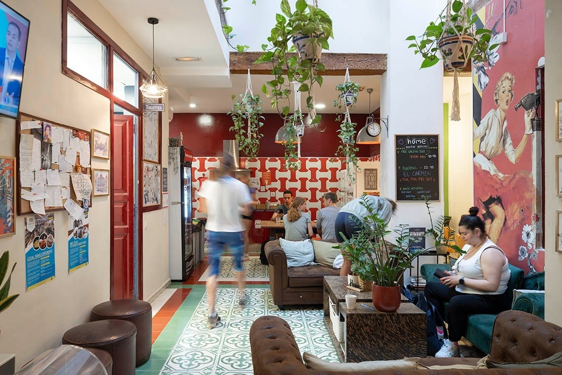 Young people enjoying a hostel's cozy atmosphere, ideal for putting feet up and relaxing.